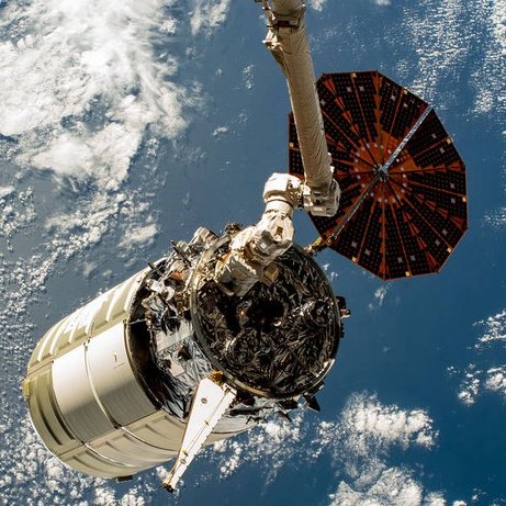 The Cygnus space freighter is poised for release from the Canadarm2 robotic arm.